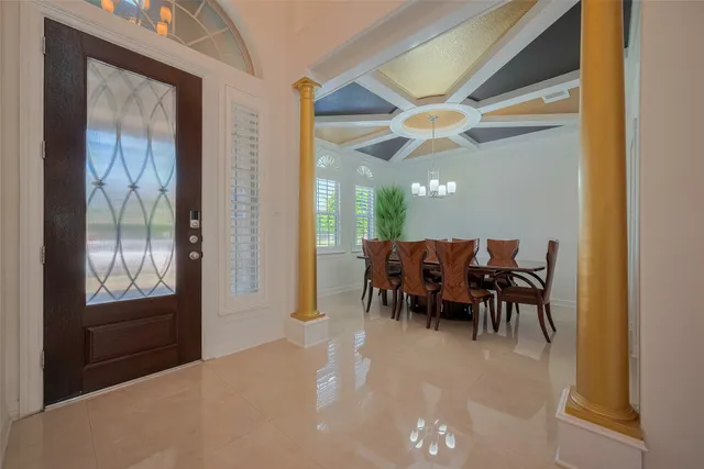 a dining room with furniture and chandelier fan