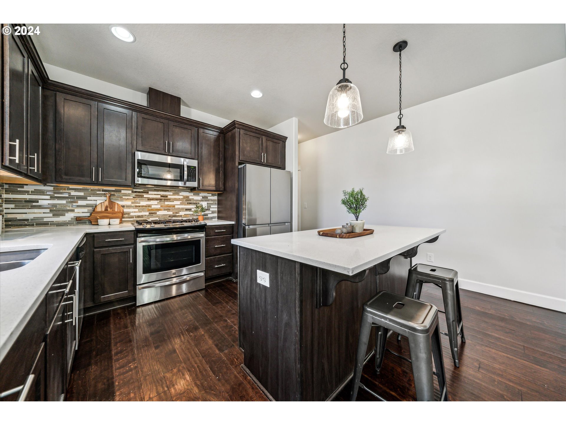 5731 Southeast Nehalem Street Portland, OR 97206 - Photo 11 of 21 a kitchen with kitchen island a counter space a sink and appliances
