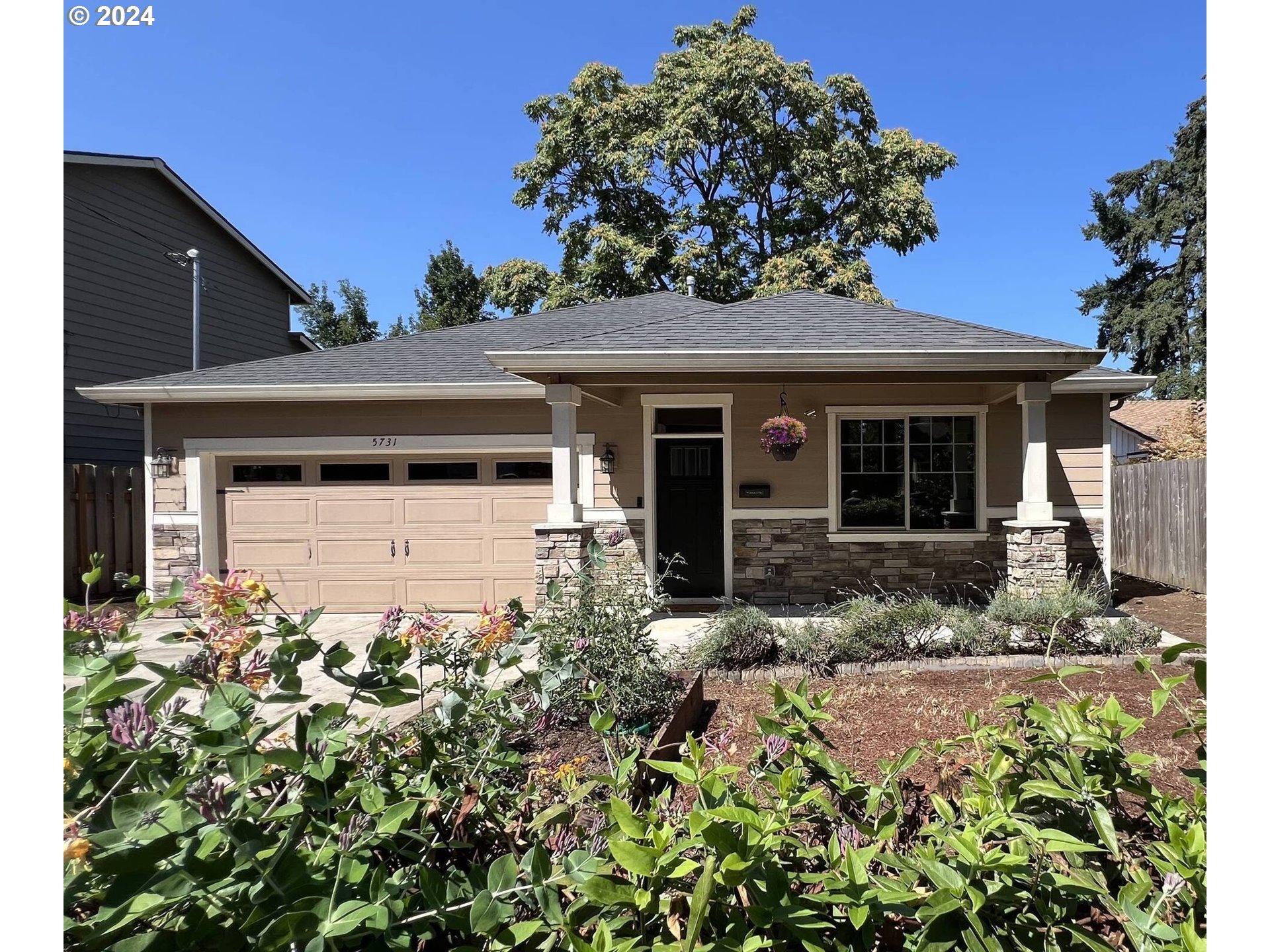 5731 Southeast Nehalem Street Portland, OR 97206 - Photo 2 of 21 front view of a house with a small yard