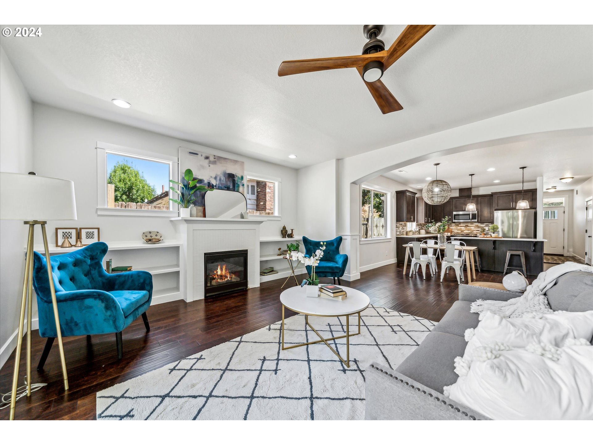 5731 Southeast Nehalem Street Portland, OR 97206 - Photo 4 of 21 a living room with furniture a fireplace and a table