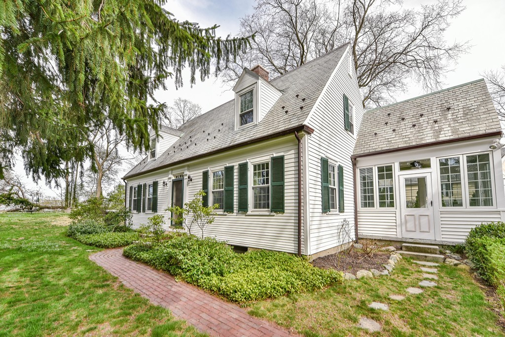 118 Wolcott Road Brookline, MA 02467 - Photo 1 of 24 a front view of a house with a garden