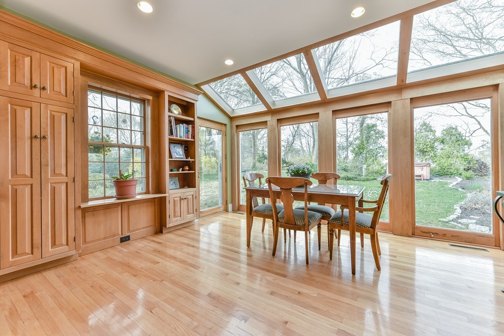 118 Wolcott Road Brookline, MA 02467 - Photo 3 of 24 a dining room with furniture large windows and wooden floor