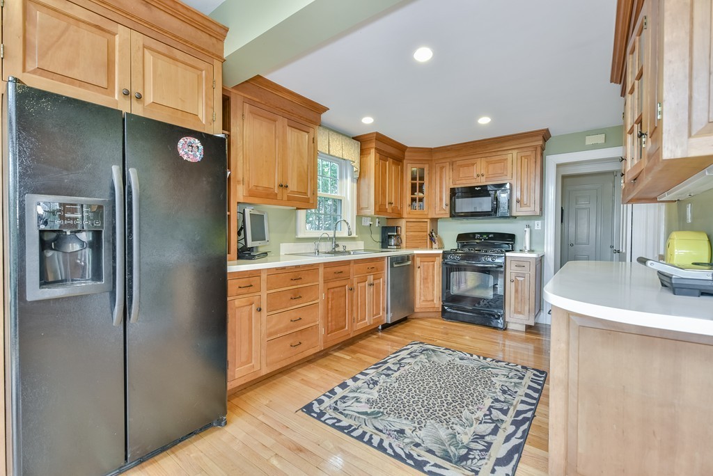 118 Wolcott Road Brookline, MA 02467 - Photo 6 of 24 a kitchen with stainless steel appliances granite countertop a refrigerator sink and cabinets