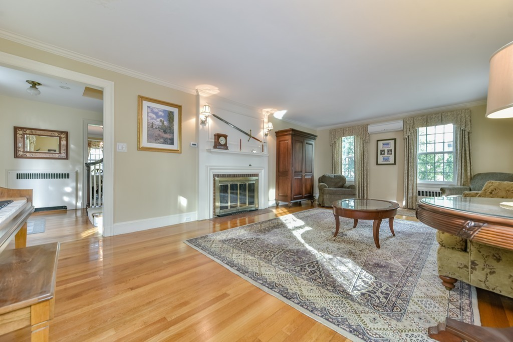 118 Wolcott Road Brookline, MA 02467 - Photo 9 of 24 a living room with furniture and a fireplace