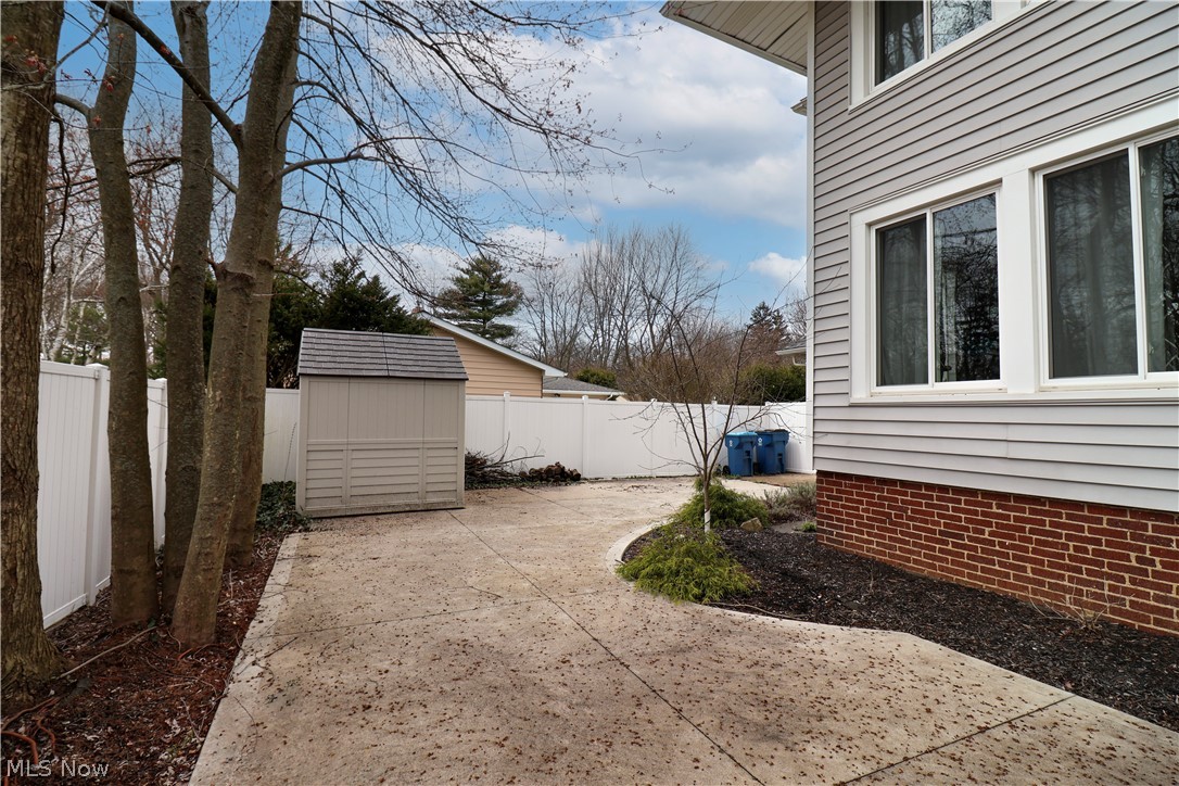 4376 Dover Center Road North Olmsted, OH 44070 - Photo 33 of 34 View of yard with a storage unit and a patio area