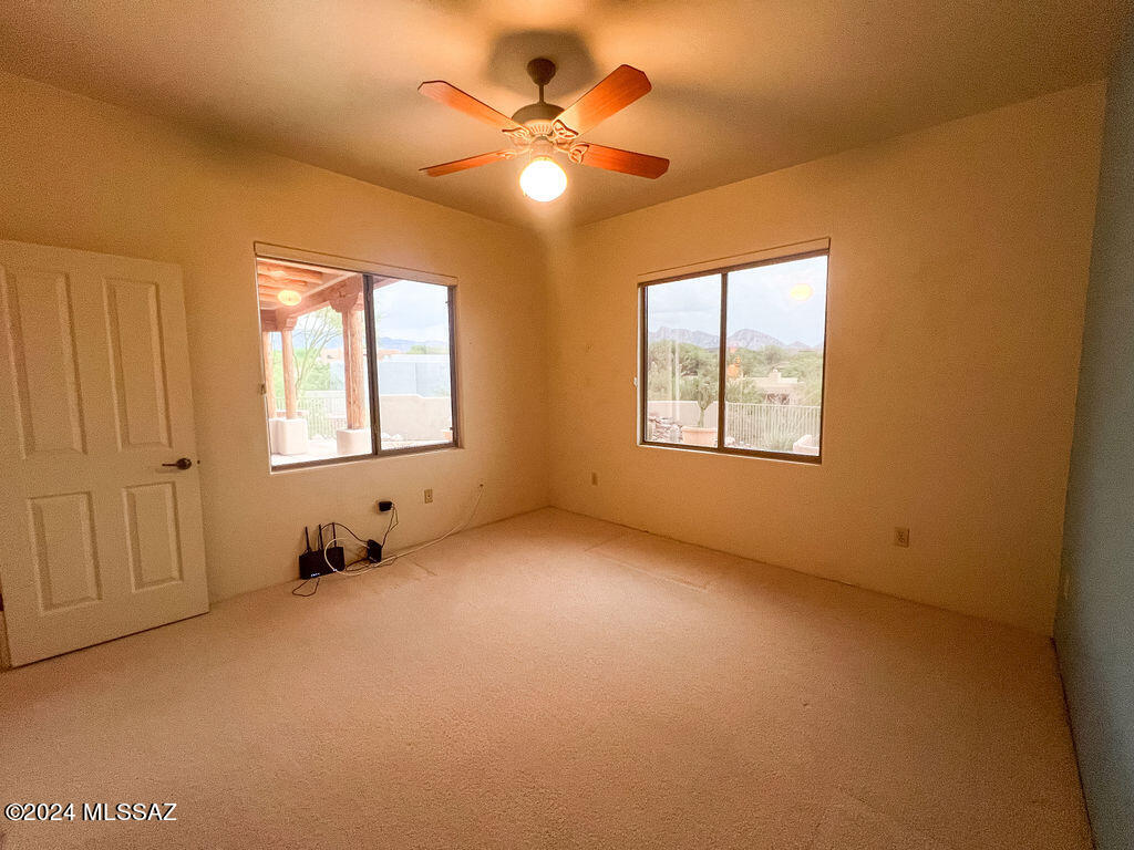771 West Sedona Ridge Place Oro Valley, AZ 85755 - Photo 21 of 22 an empty room with windows and fan