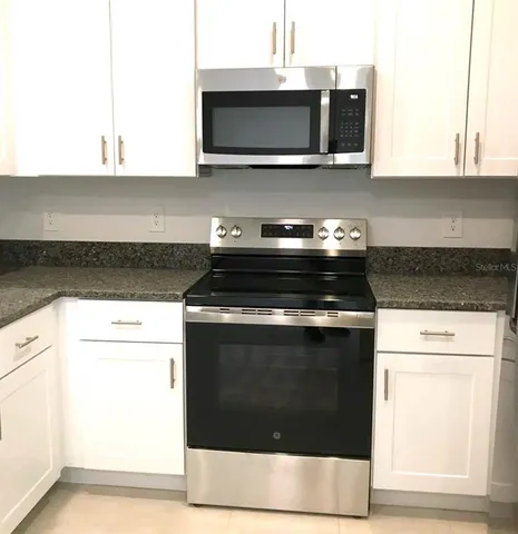 a stove top oven sitting inside of a kitchen