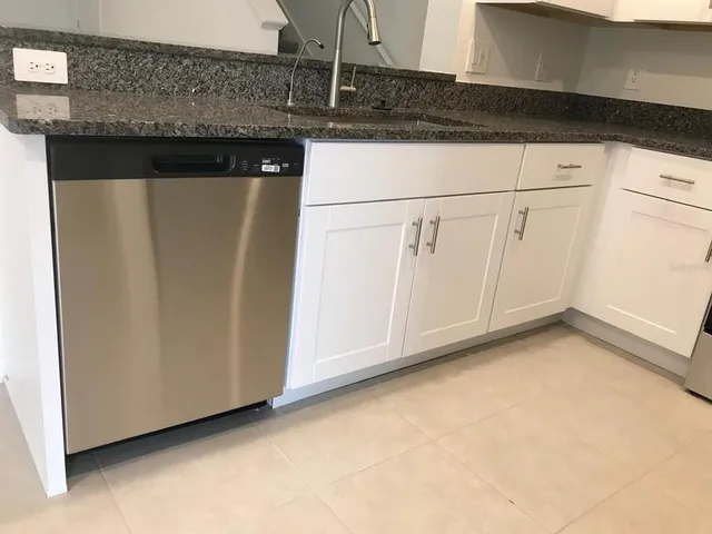 a view of a kitchen with granite countertop cabinets