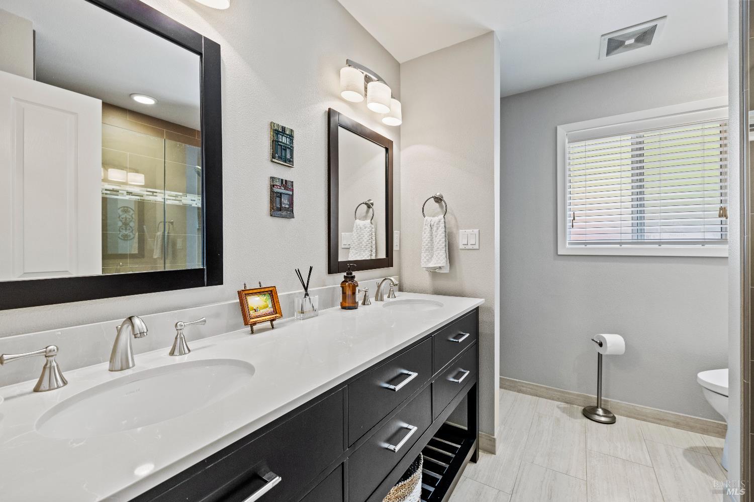 1389 Canyon Road Geyserville, CA 95441 - Photo 28 of 59 a bathroom with a double vanity sink and a mirror