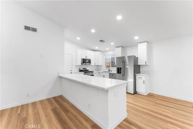 a view of kitchen with wooden floor