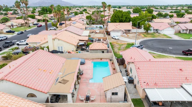 an aerial view of residential houses with outdoor space