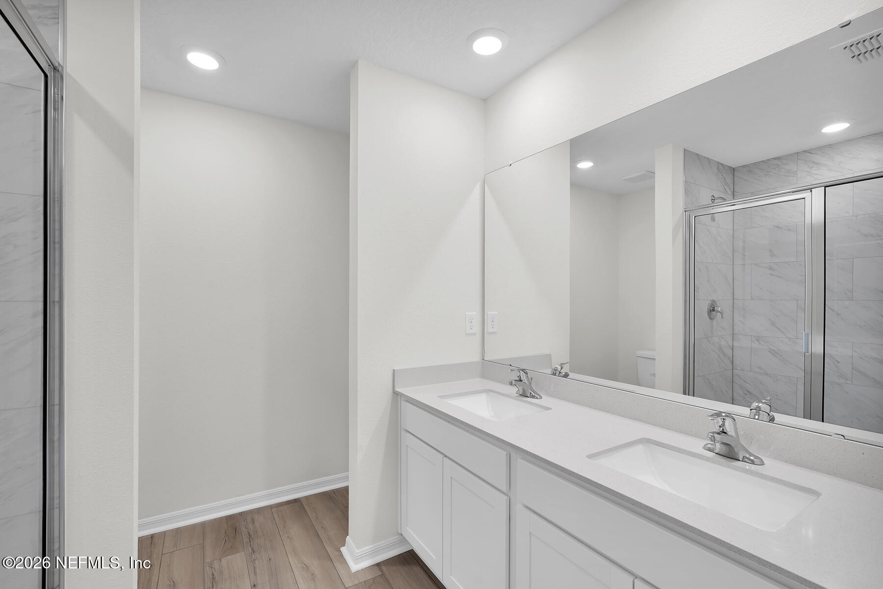 6949 Canoe Birch Road Jacksonville, FL 32219 - Photo 15 of 22 a bathroom with a double vanity sink and a mirror