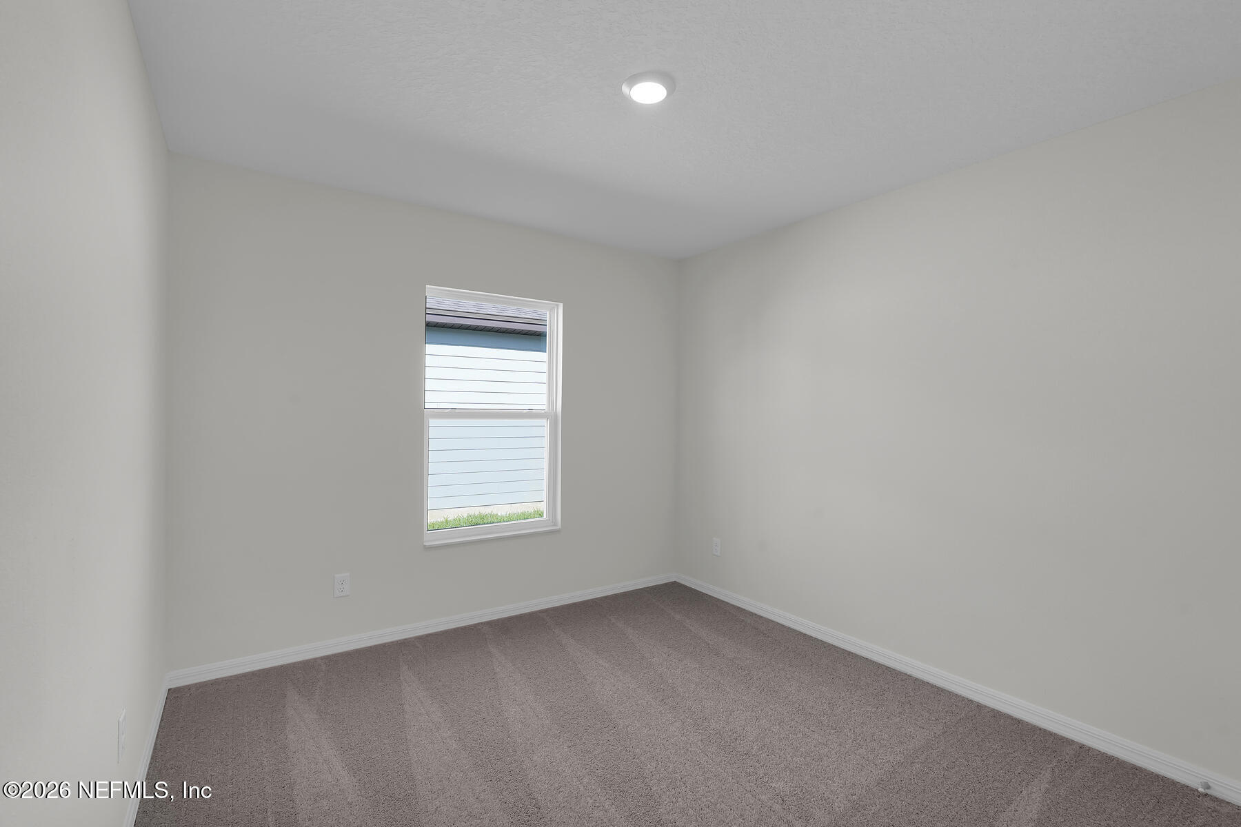 6949 Canoe Birch Road Jacksonville, FL 32219 - Photo 18 of 22 an empty room with a window and a bathroom