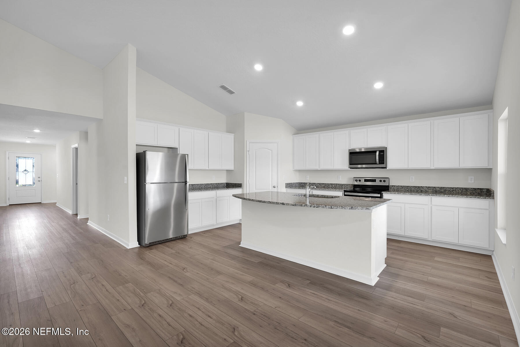 6949 Canoe Birch Road Jacksonville, FL 32219 - Photo 3 of 22 a kitchen with stainless steel appliances a refrigerator and wooden floor