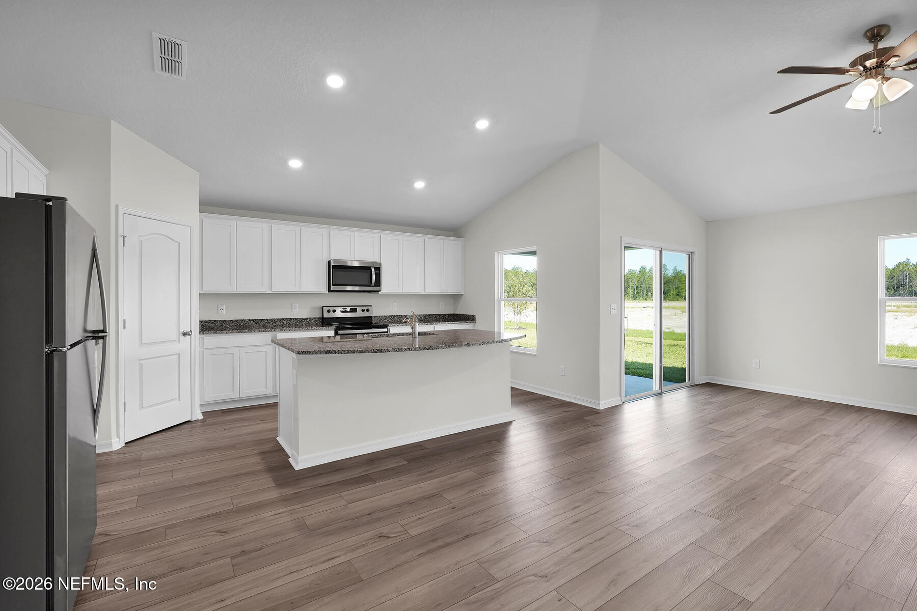 6949 Canoe Birch Road Jacksonville, FL 32219 - Photo 5 of 22 a view of kitchen with refrigerator stove and wooden floor