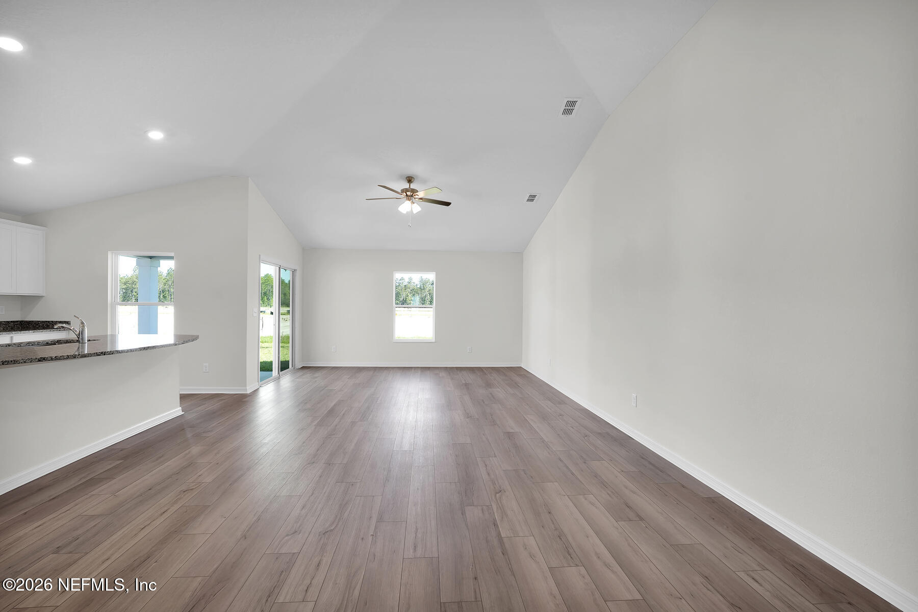 6949 Canoe Birch Road Jacksonville, FL 32219 - Photo 10 of 22 a view of an empty room with wooden floor and a window