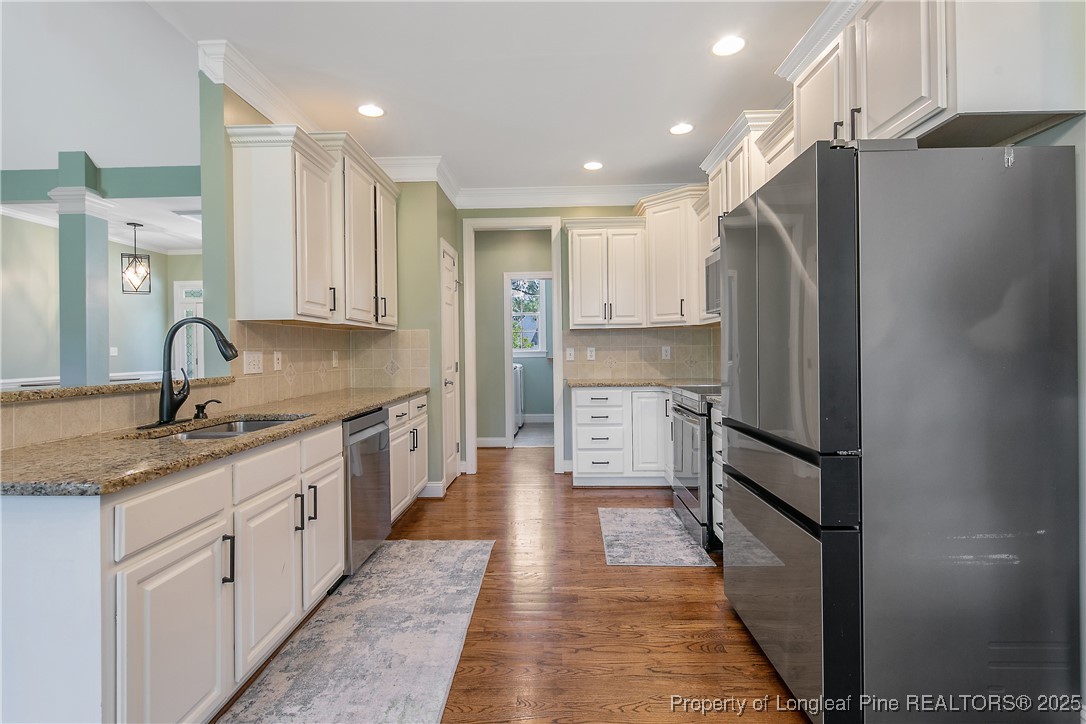 533 Falling Water Road Spring Lake, NC 28390 - Photo 18 of 50 a kitchen with stainless steel appliances granite countertop a refrigerator and a sink