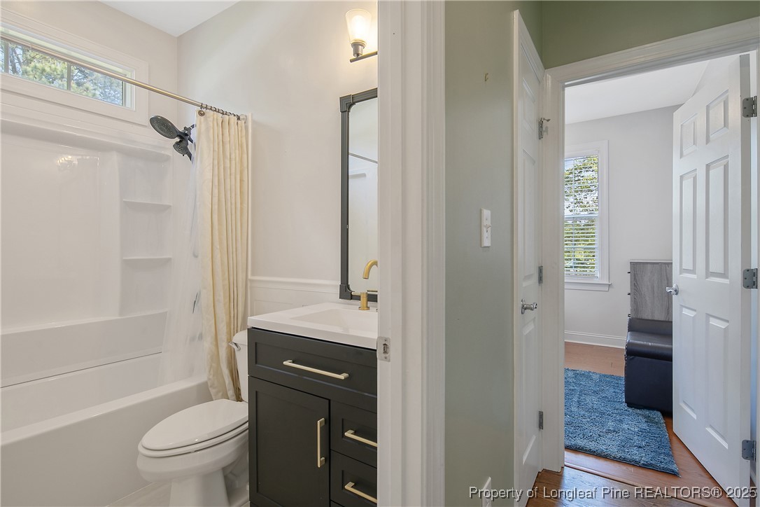 533 Falling Water Road Spring Lake, NC 28390 - Photo 36 of 50 a bathroom with a granite countertop toilet a sink and shower