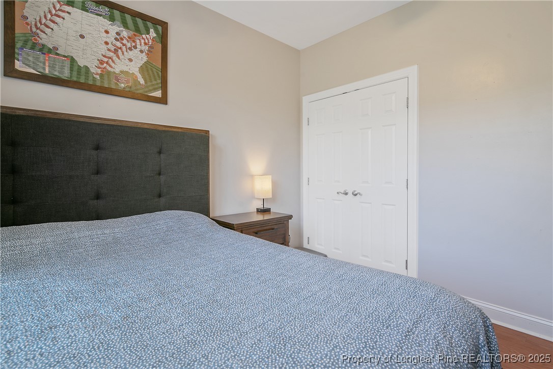 533 Falling Water Road Spring Lake, NC 28390 - Photo 39 of 50 a bedroom with a bed and a painting on the wall