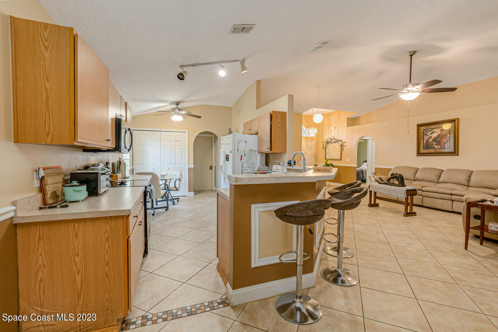 2154 Spring Creek Circle Palm Bay, FL 32905 - Photo 13 of 35 a lobby with furniture and a view of living room