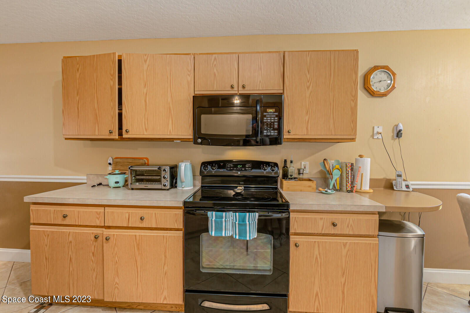 2154 Spring Creek Circle Palm Bay, FL 32905 - Photo 14 of 35 a kitchen with a stove and a microwave