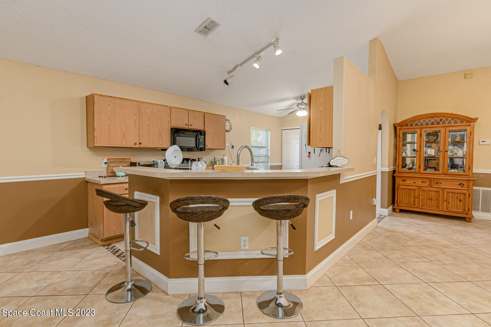 2154 Spring Creek Circle Palm Bay, FL 32905 - Photo 15 of 35 a kitchen with stainless steel appliances granite countertop a stove a sink and a refrigerator