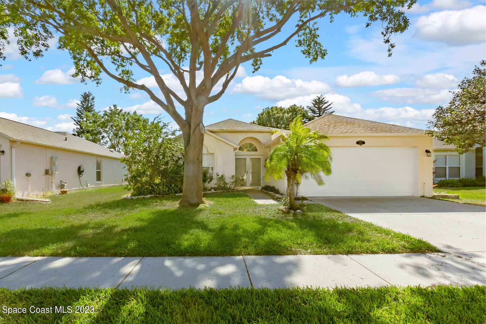 2154 Spring Creek Circle Palm Bay, FL 32905 - Photo 2 of 35 a front view of a house with garden