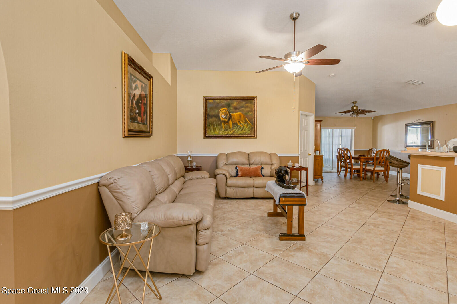 2154 Spring Creek Circle Palm Bay, FL 32905 - Photo 21 of 35 a living room with furniture and a chandelier