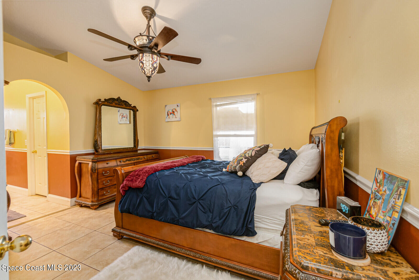 2154 Spring Creek Circle Palm Bay, FL 32905 - Photo 25 of 35 a bedroom with a bed and wooden floor