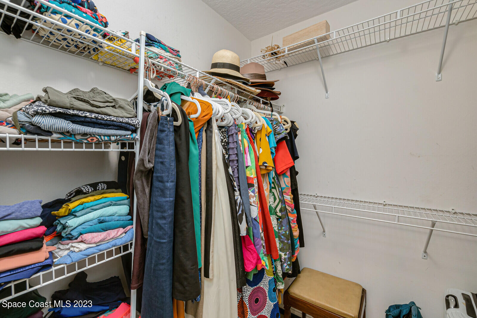2154 Spring Creek Circle Palm Bay, FL 32905 - Photo 26 of 35 a view of walk in closet with clothes and shoes