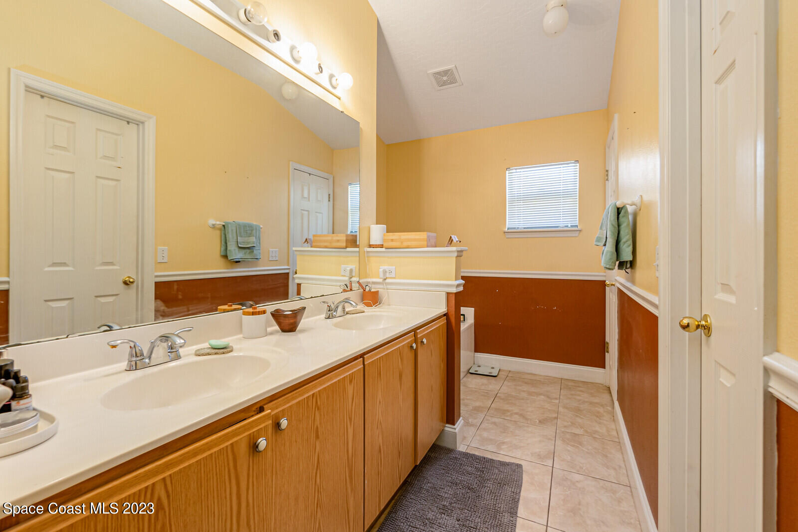 2154 Spring Creek Circle Palm Bay, FL 32905 - Photo 27 of 35 a bathroom with a sink double vanity and a mirror