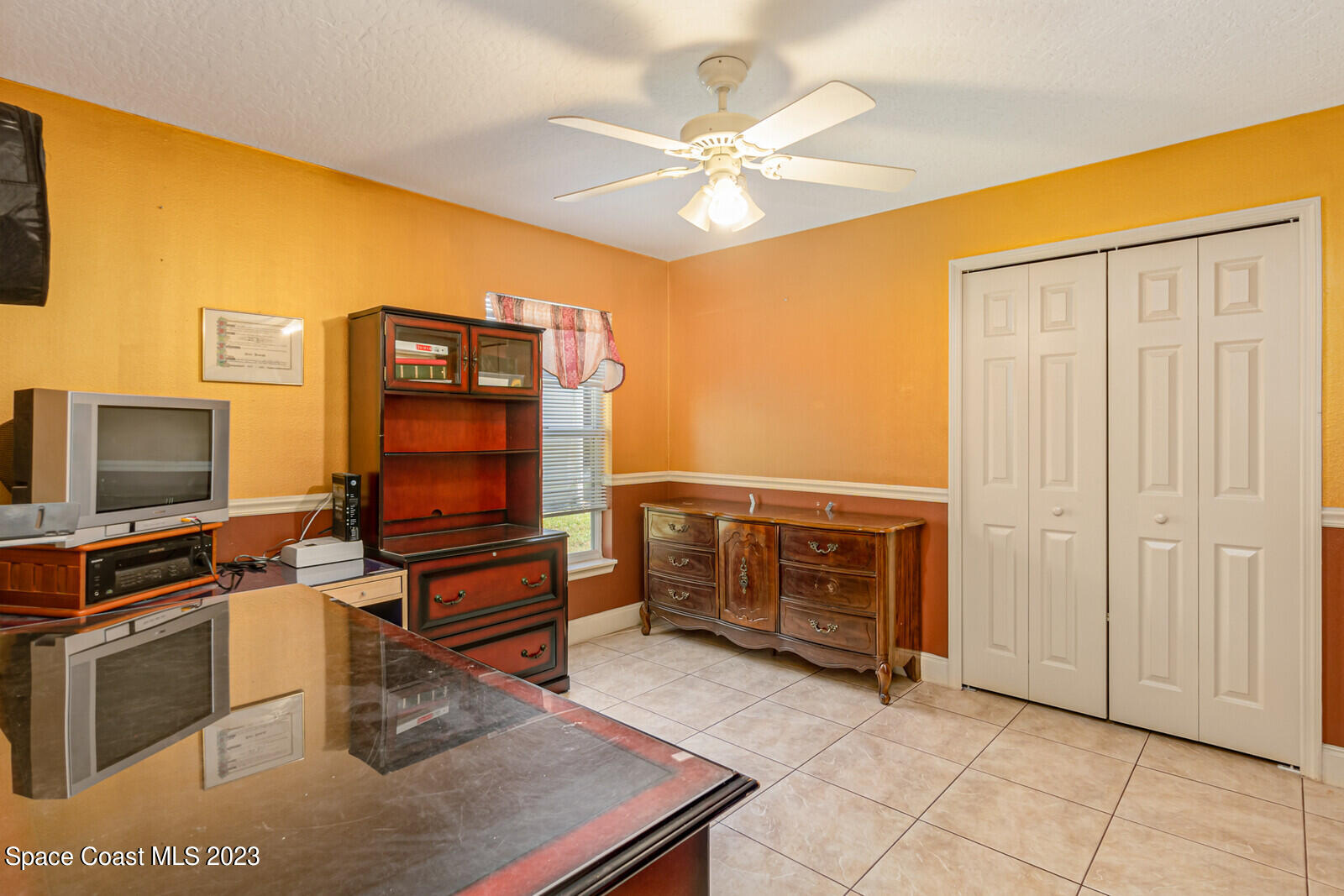 2154 Spring Creek Circle Palm Bay, FL 32905 - Photo 30 of 35 a bedroom with furniture and flat screen tv