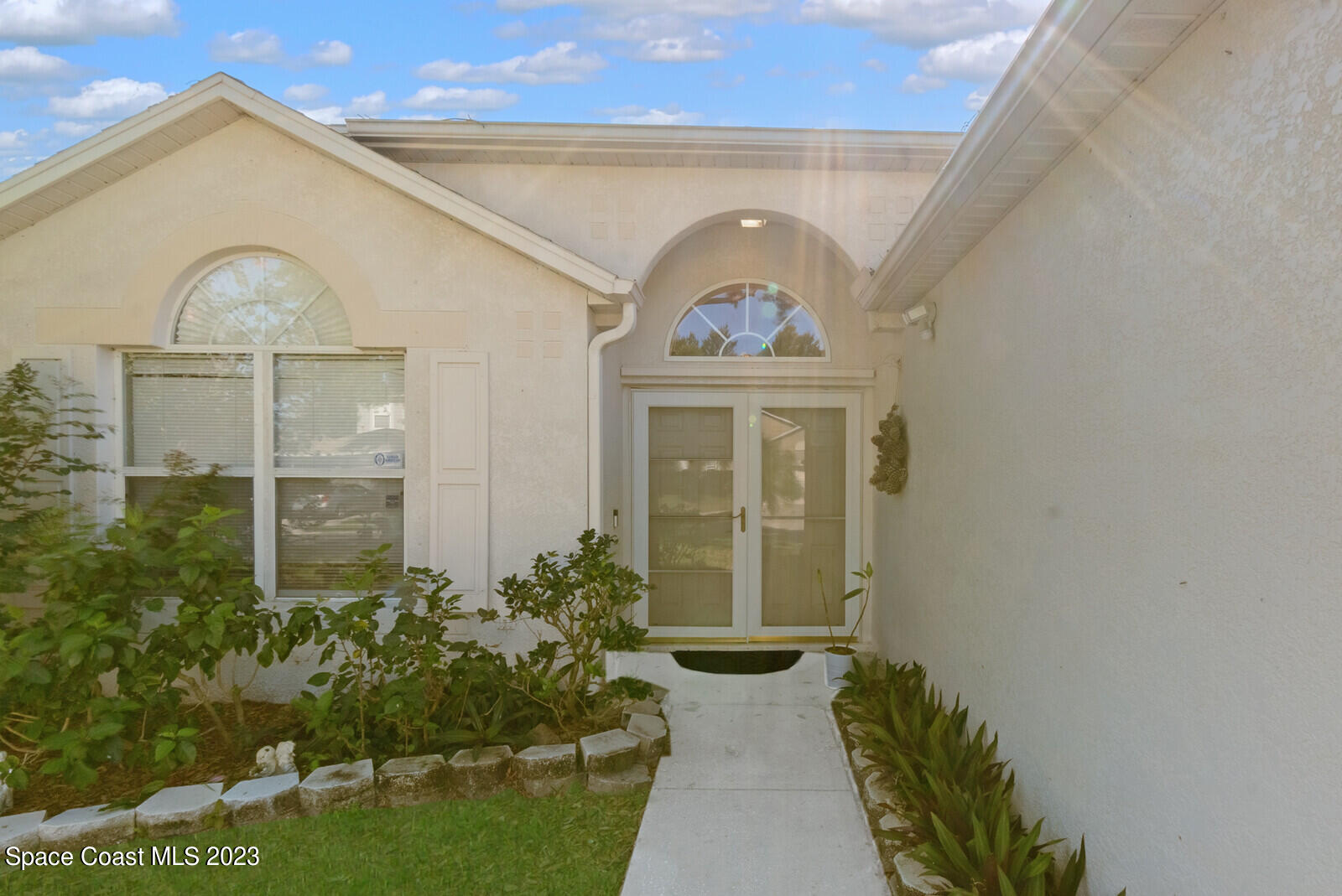 2154 Spring Creek Circle Palm Bay, FL 32905 - Photo 3 of 35 a front view of a house with garden