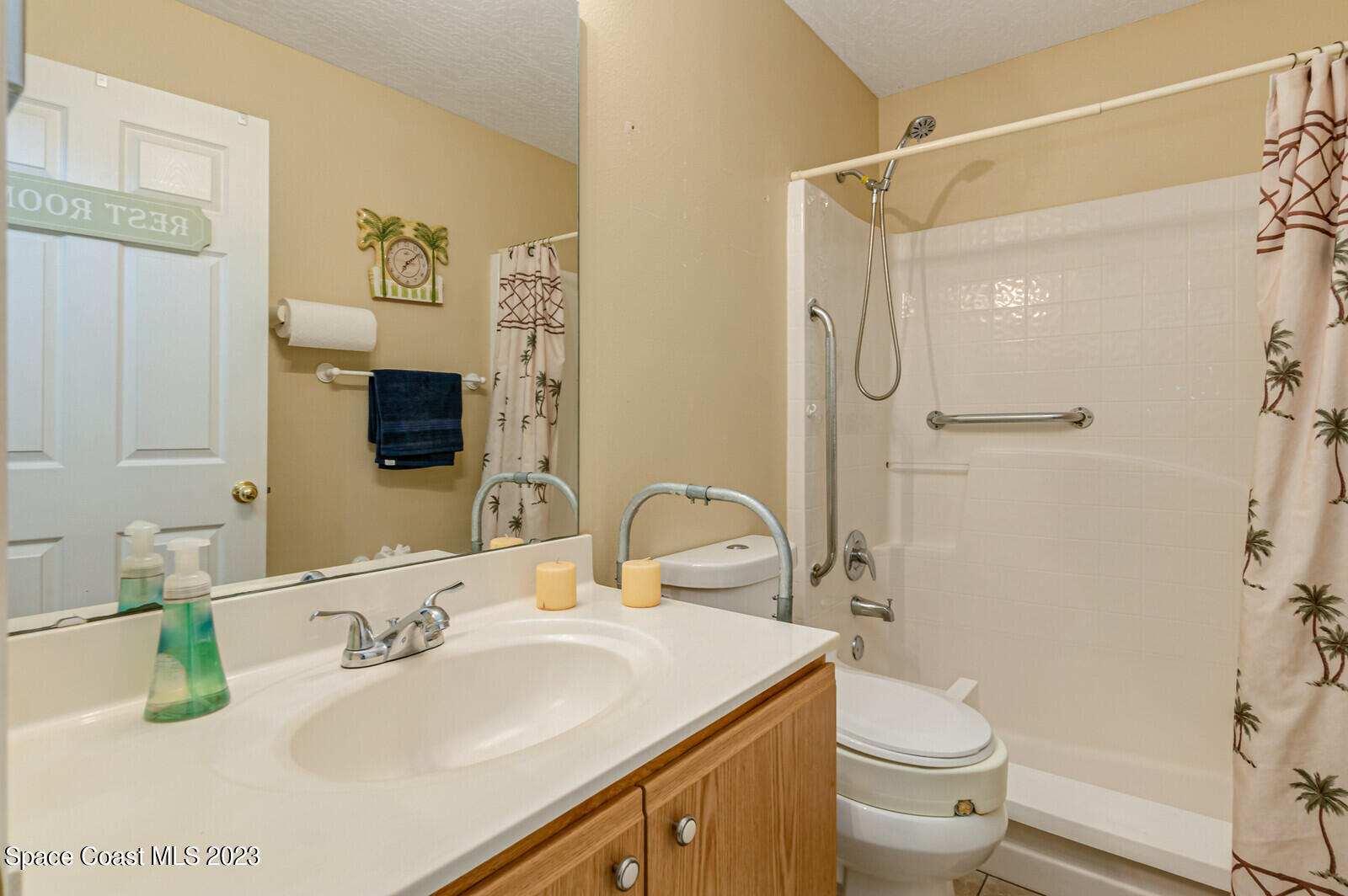 2154 Spring Creek Circle Palm Bay, FL 32905 - Photo 32 of 35 a bathroom with a granite countertop sink toilet and shower