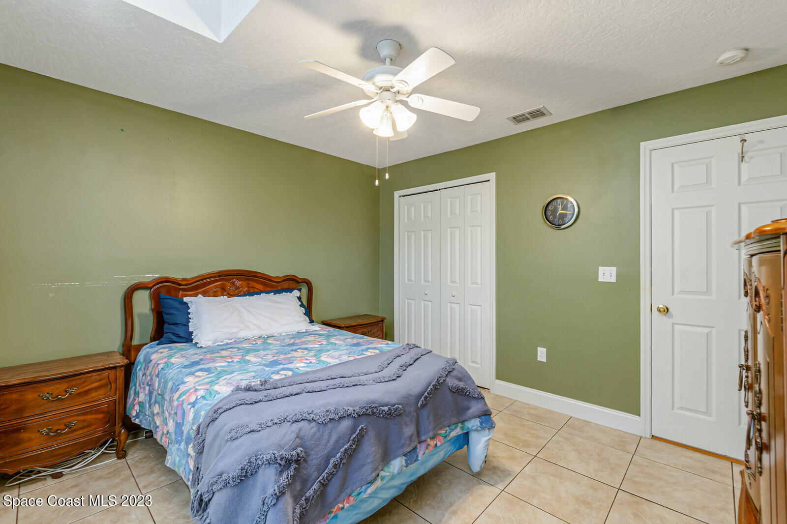 2154 Spring Creek Circle Palm Bay, FL 32905 - Photo 35 of 35 a bedroom with a bed and a chandelier