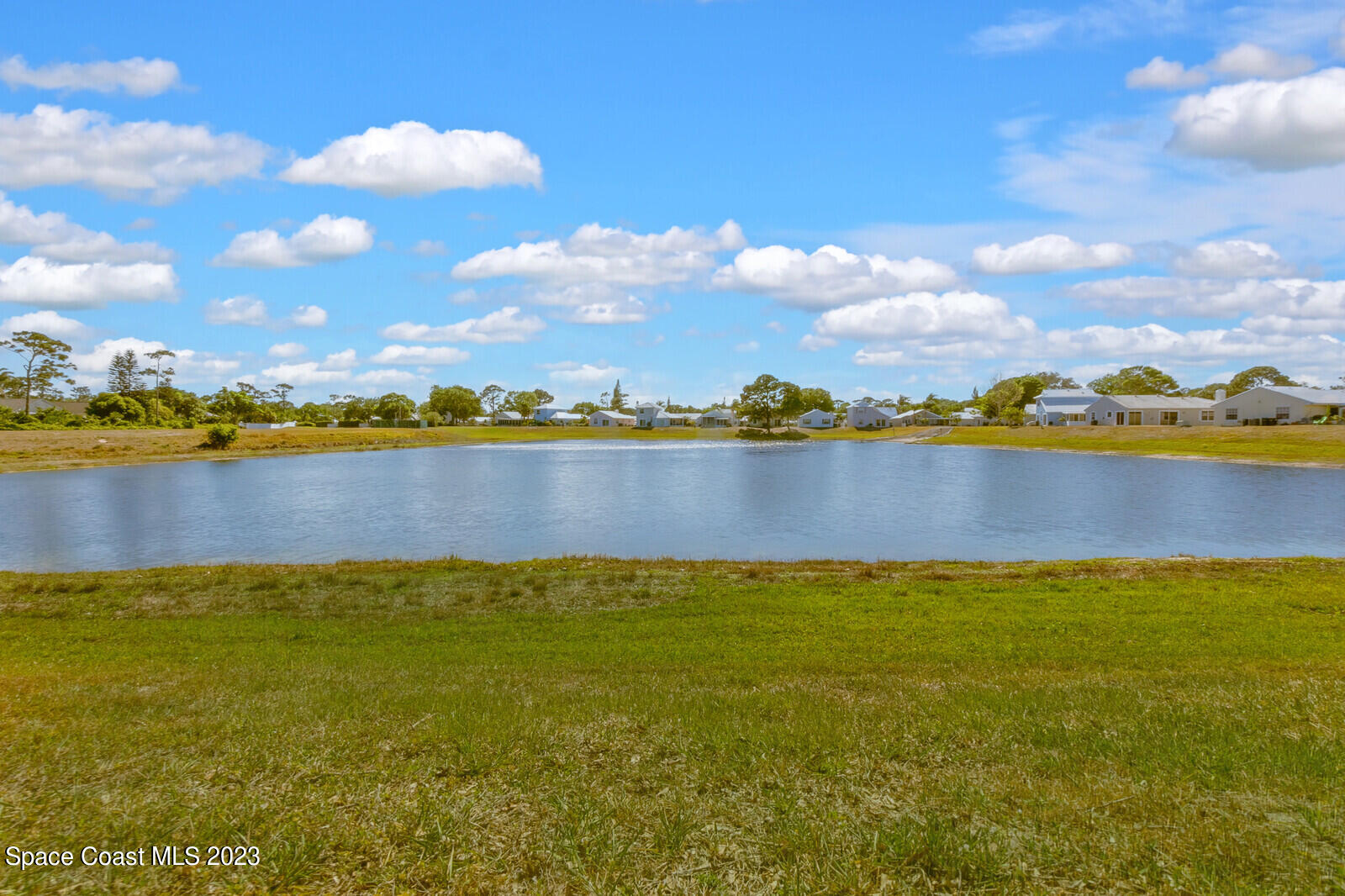 2154 Spring Creek Circle Palm Bay, FL 32905 - Photo 5 of 35 a view of a lake with houses in the background