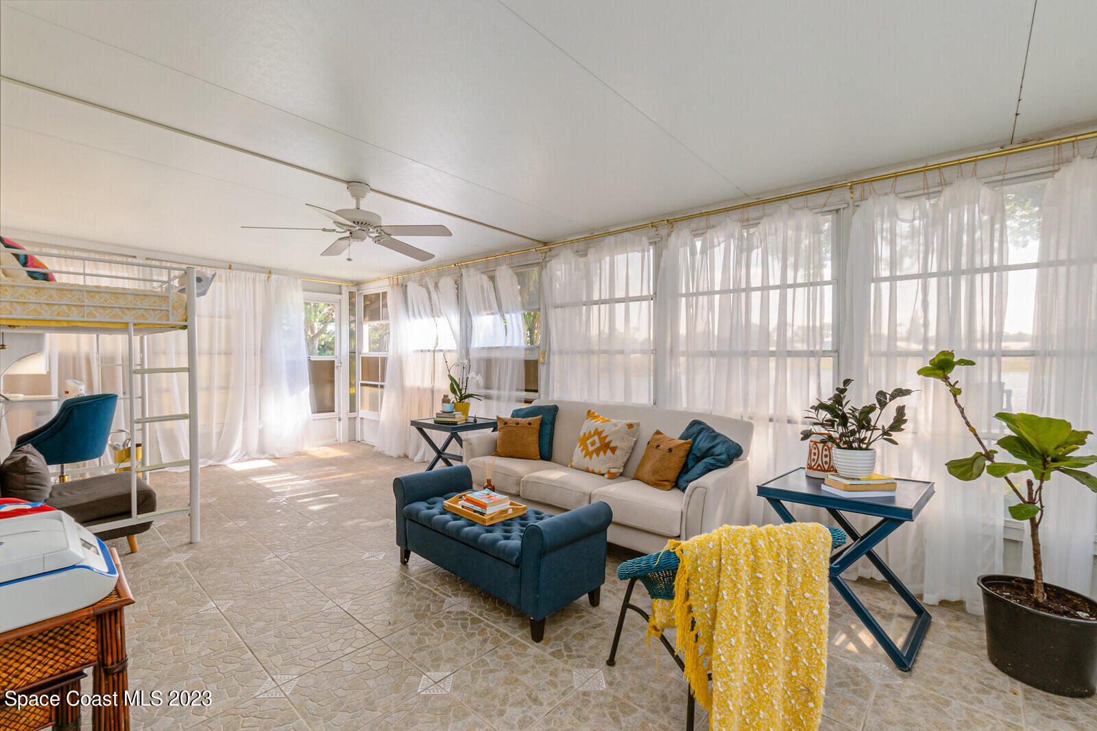 2154 Spring Creek Circle Palm Bay, FL 32905 - Photo 7 of 35 a living room with furniture and a large window