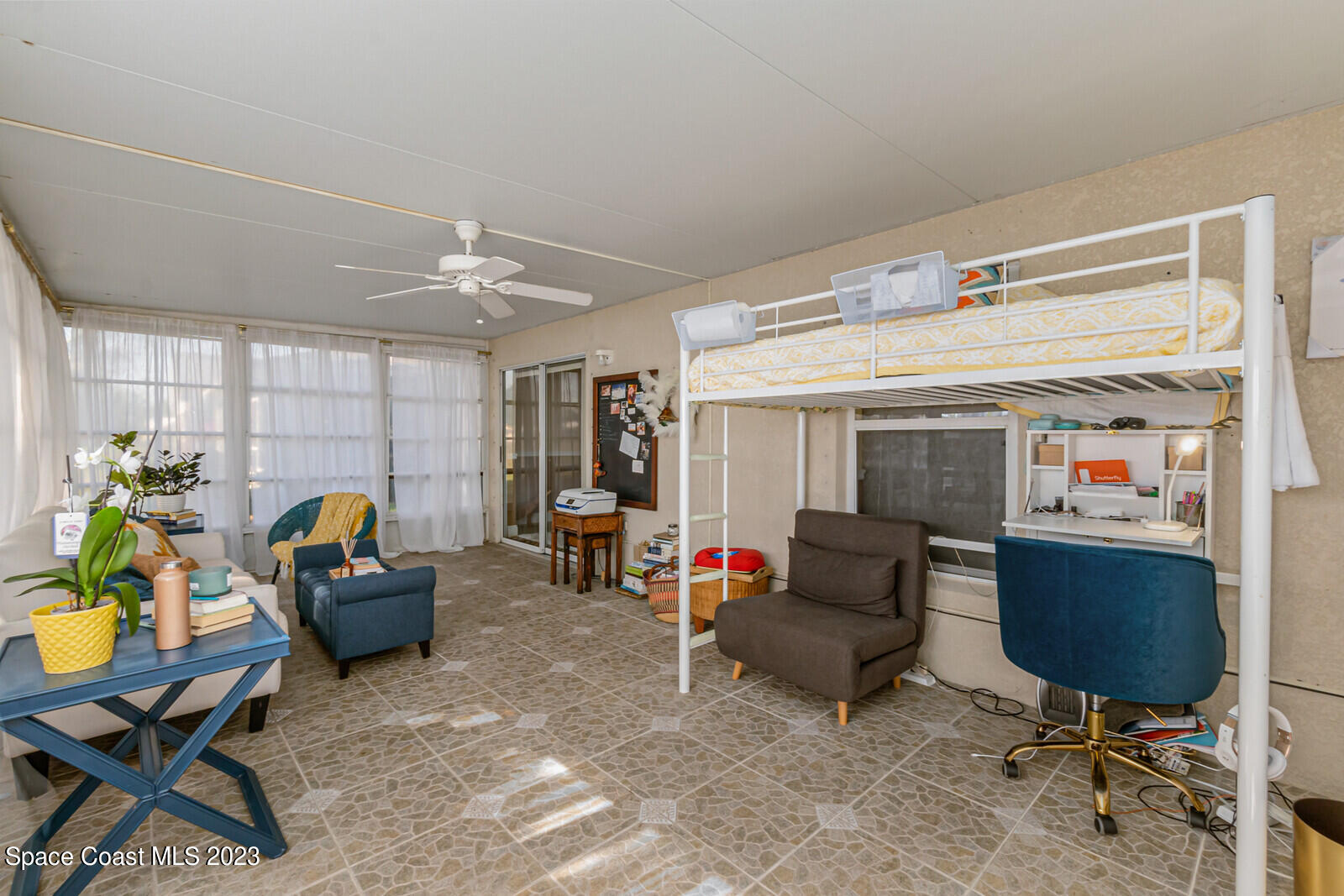 2154 Spring Creek Circle Palm Bay, FL 32905 - Photo 9 of 35 a living room with furniture and a work place