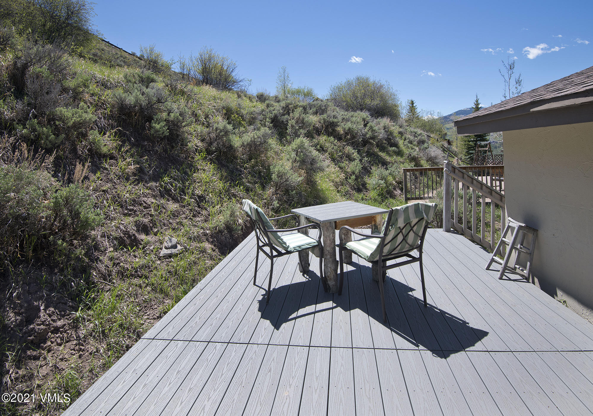 1066 West Wildwood Road, Unit D Avon, CO 81620 - Photo 17 of 21 a view of a roof deck with table and chairs with wooden floor and fence