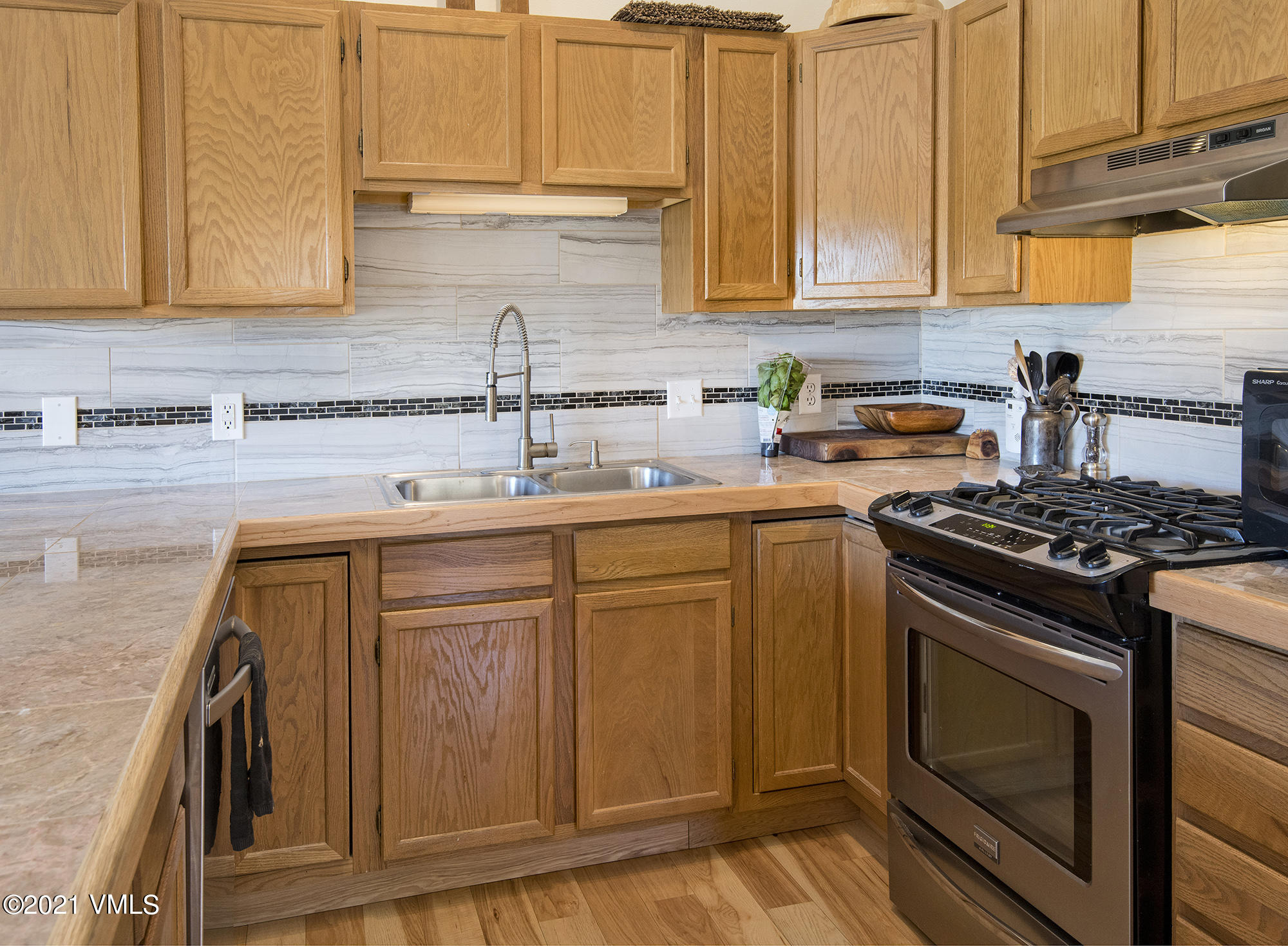 1066 West Wildwood Road, Unit D Avon, CO 81620 - Photo 4 of 21 a kitchen with stainless steel appliances granite countertop a sink stove and cabinets