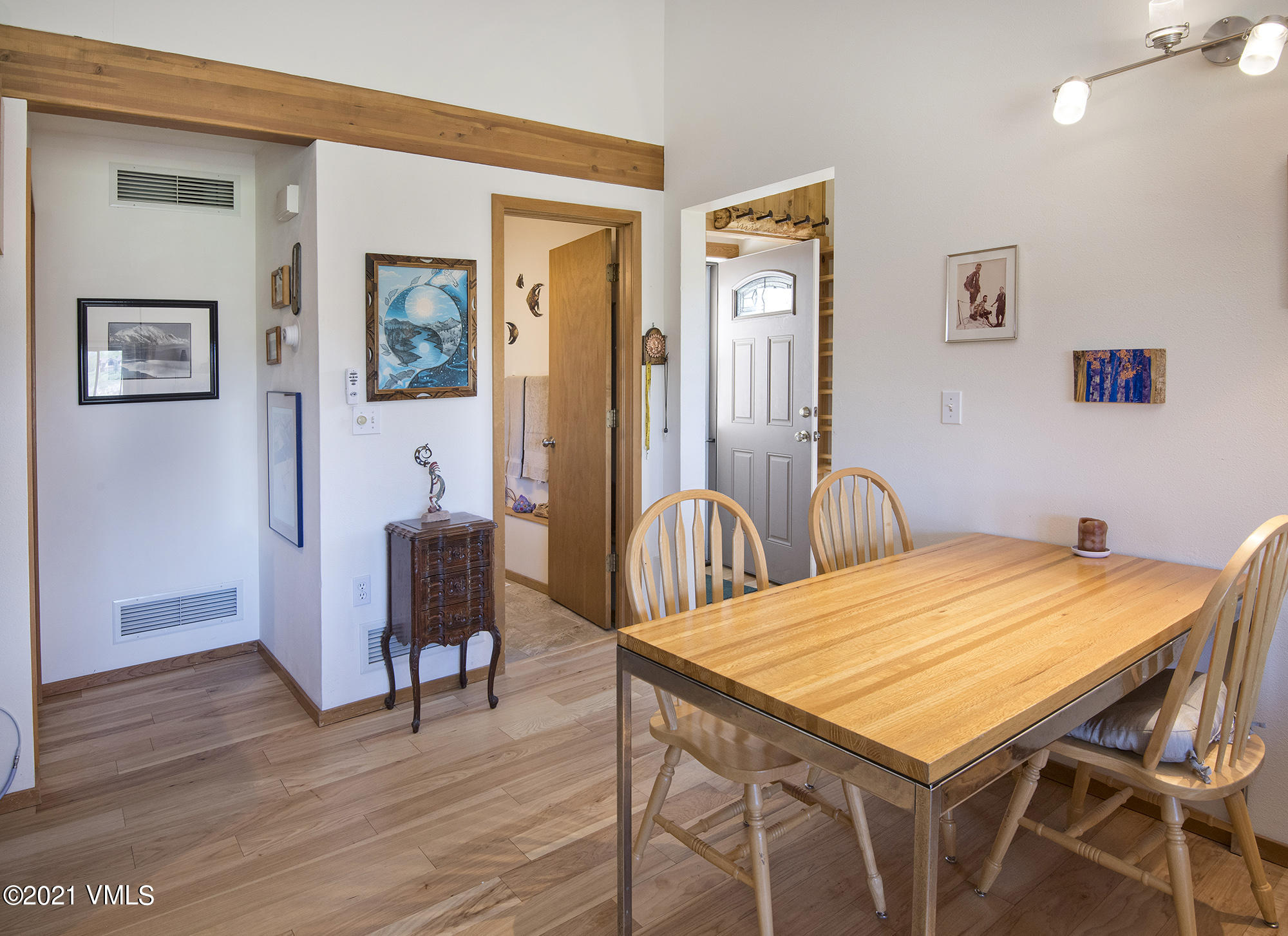 1066 West Wildwood Road, Unit D Avon, CO 81620 - Photo 5 of 21 a view of a dining room with furniture and wooden floor