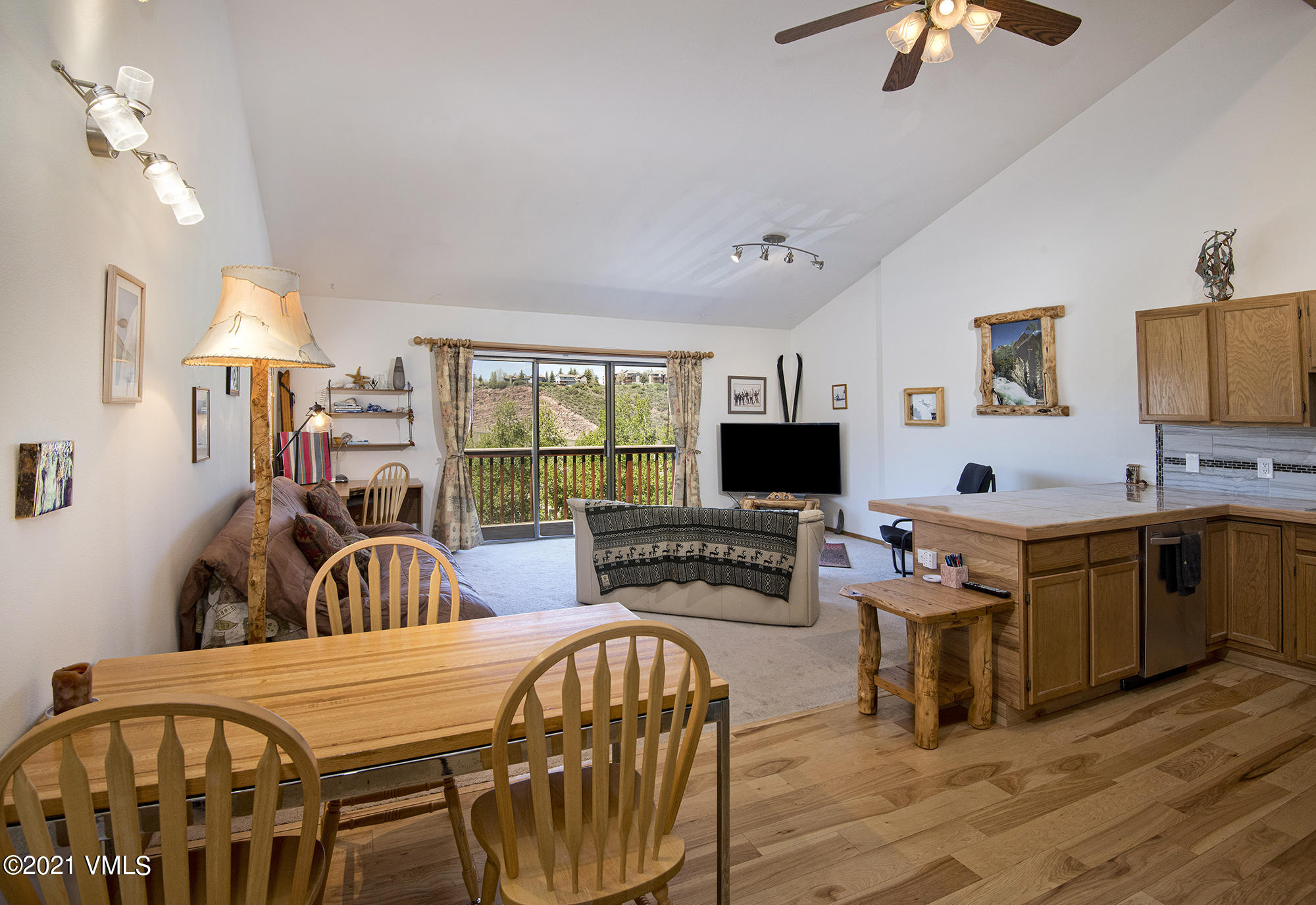 1066 West Wildwood Road, Unit D Avon, CO 81620 - Photo 6 of 21 a very nice looking living room with a large window a flat screen tv and furniture