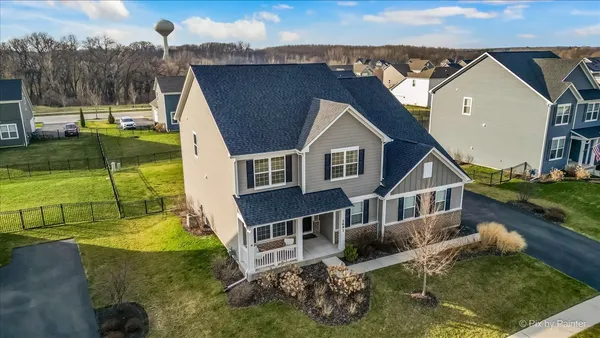 an aerial view of a house with a yard