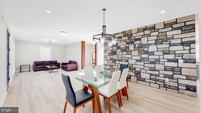 a large kitchen with stainless steel appliances kitchen island granite countertop a sink a stove a refrigerator and island with wooden floor