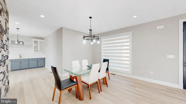 a kitchen with stainless steel appliances granite countertop a stove a sink a refrigerator and a refrigerator with wooden floor