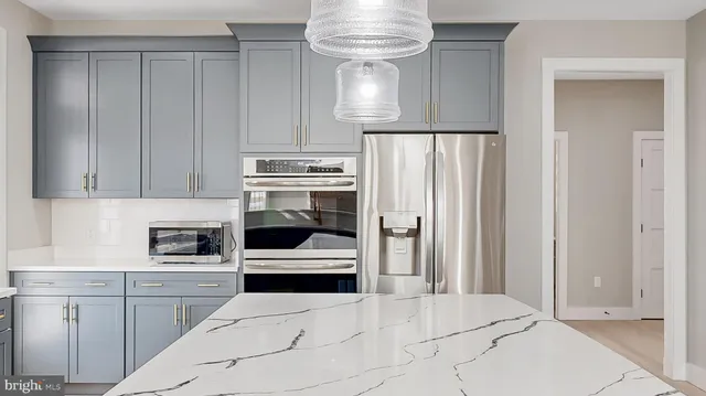 a view of a hallway with wooden floor and stairs