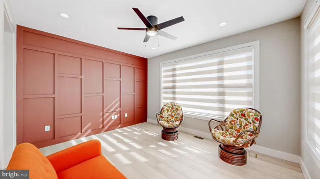 a spacious bedroom with a bed and a ceiling fan