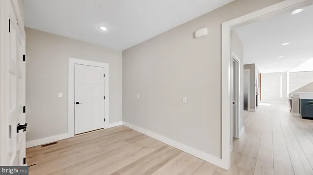 a spacious bedroom with a bed and a ceiling fan