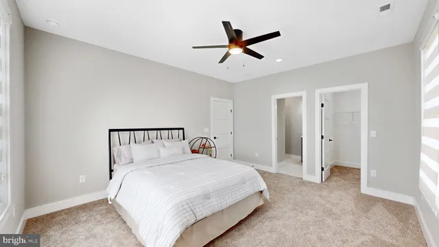 a bathroom with a double vanity sink toilet mirror and shower