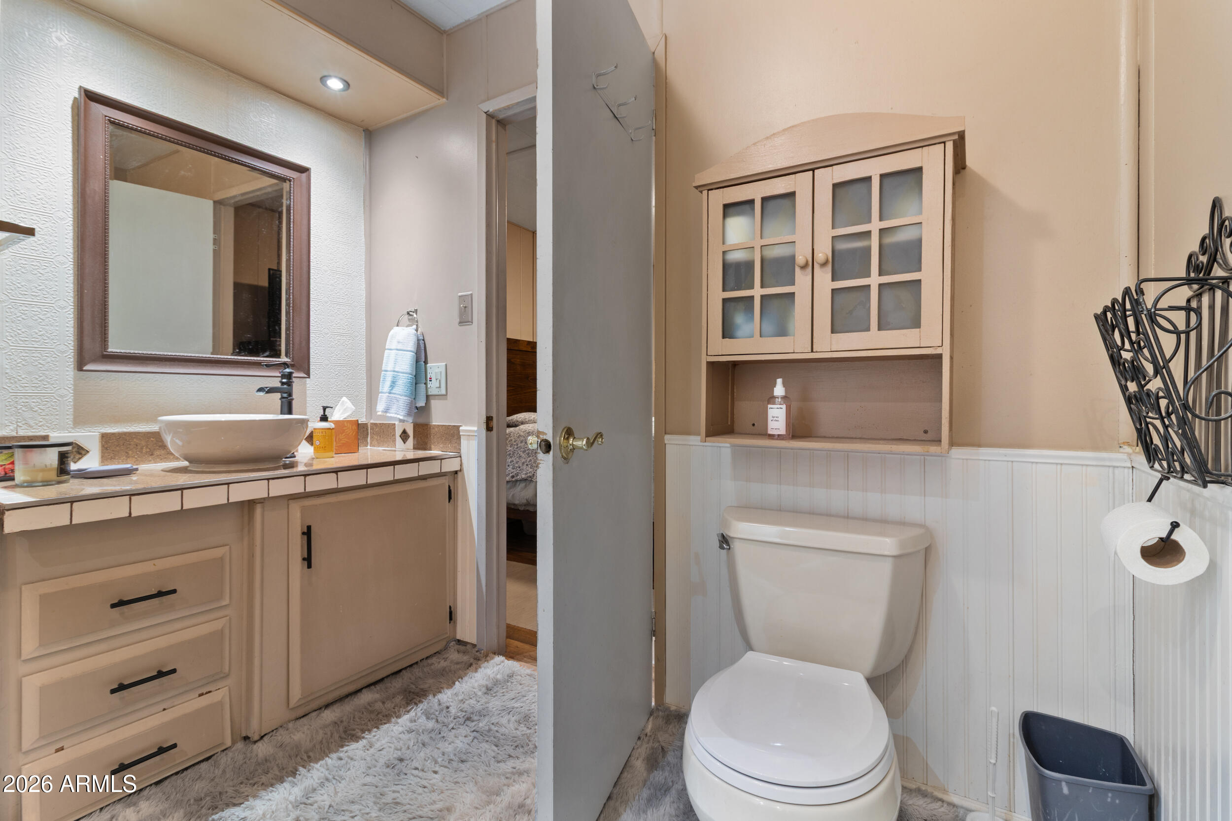 535 South Alma School Road, Unit 99 Mesa, AZ 85210 - Photo 28 of 77 a bathroom with a toilet a sink and mirror